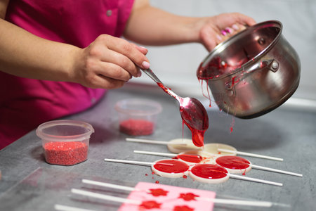 process of making delicious lollipops by pouring them into molds