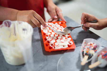 pastry chef fills silicone molds with cream