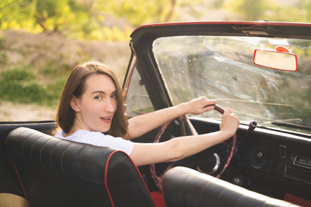 beautiful happy girl in a skirt posing near a retro car in the mountains of cappadocia