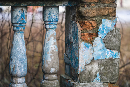 a balustrade on the railing of an old cracked staircase