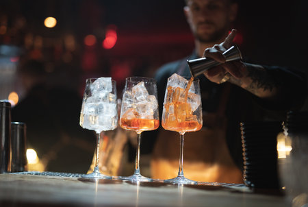 the bartender prepares a beautiful alcoholic cocktail at the bar counterの写真素材