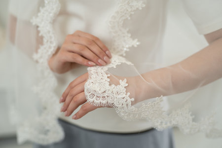 wedding veil close-up of embroidered pattern on handの写真素材