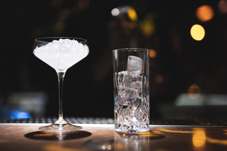 the bartender prepares a beautiful alcoholic cocktail at the bar counterの写真素材