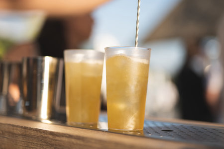 the bartender behind the bar makes an alcoholic cocktail