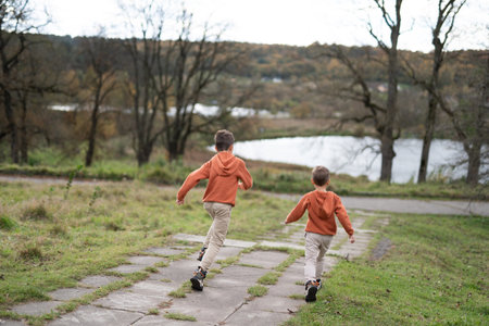 two little boys of the brothers run playfullyの写真素材