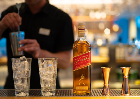 LVIV, UKRAINE - SEPTEMBER 2, 2022: Johnnie Walker Red Label, the bartender prepares a cocktailのeditorial素材