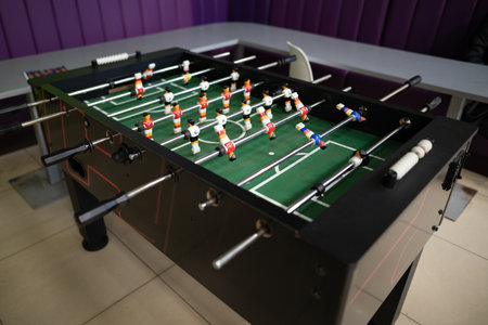 A close-up of the table football game of football figures on the field
