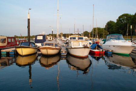 beautiful ships and boats are moored near the shore
