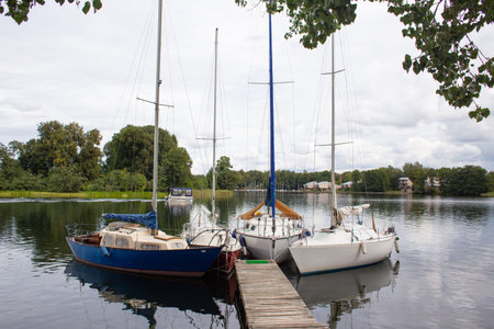 beautiful ships and boats are moored near the shoreの写真素材