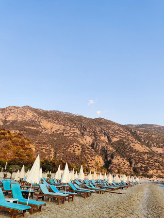 deck chairs and umbrellas on the sea beach in summer
