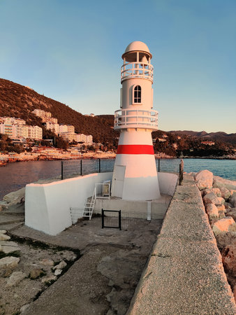 beautiful lighthouse tower on the coast at sunsetの写真素材