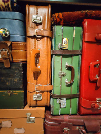 different colored vintage suitcases stacked on top of each otherの写真素材