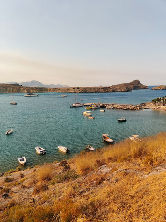 beautiful ships and boats are moored near the shoreの写真素材