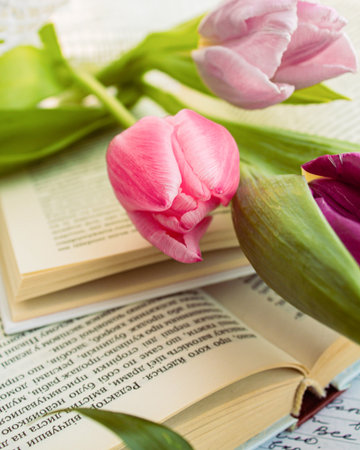 a beautiful arrangement of a bouquet of tulip flowers and a bookの写真素材