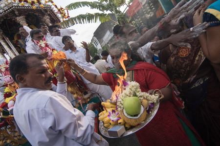 GEORGETOWN, PENANG/MALAYSIA ?? CIRCA FEB 2017: A woman prepare coconut, fruits, flowers and incense on a Thaambalam (big silver plate) during Thaipusam celebration.のeditorial素材