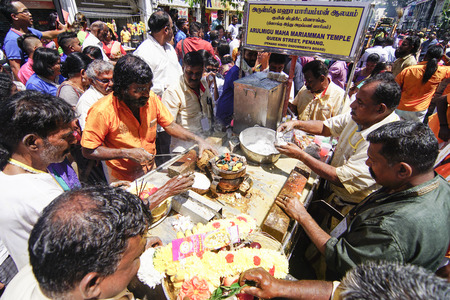 GEORGETOWN, PENANG/MALAYSIA ?? CIRCA FEB 2017: Devotees get coconut cut before offering to lord Muruga during Thaipusam festival.のeditorial素材