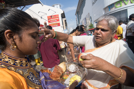 GEORGETOWN, PENANG/MALAYSIA ?? CIRCA FEB 2017: An old woman bless young woman with incense during thaipusam celebration.のeditorial素材