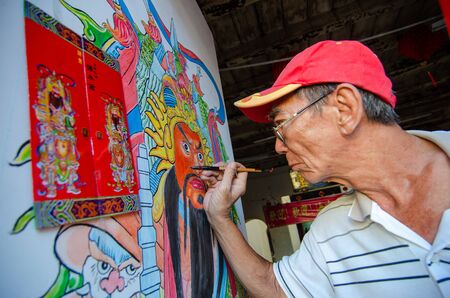 George Town, Penang/Malaysia - Jan 01 2016: A Chinese artist draw a "door god" at the temple.のeditorial素材