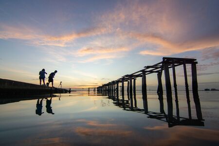 George Town, Penang/Malaysia - Jan 02 2016: Silhouette Photographer beside broken bridge at sea in the early dramatic sky morning.のeditorial素材