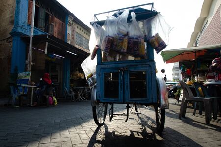 George Town, Penang/Malaysia - Mar 06 2016: Benggali bread seller (Roti man) ride his trishaw at street.のeditorial素材