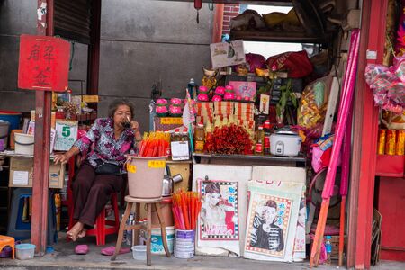 George Town, Penang/Malaysia - Aug 07 2016: An elder woman rest at the joss stick stall near Goddess of Mercy temple.のeditorial素材