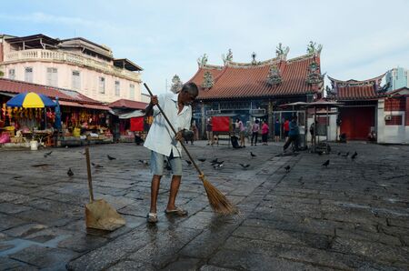 George Town, Penang/Malaysia - Aug 14 2016: A India man clean the floor at Goddess of Mercy temple.のeditorial素材