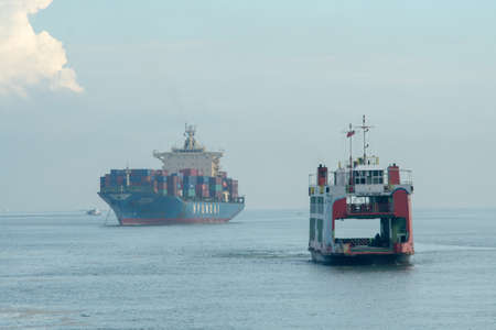 George Town, Penang/Malaysia - Jun 27 2017: Aerial view ferry move at sea. back is container shipのeditorial素材