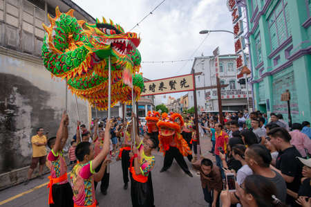George Town, Penang/Malaysia - Jul 07 2017: Dragon dance and lion dance perform at street.のeditorial素材