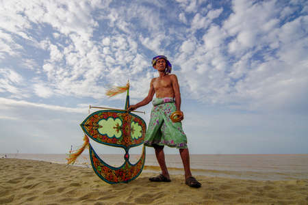 Kelantan/Malaysia - Jul 15 2017: Shafie Jusoh stand with his moon kite (wau bulan).