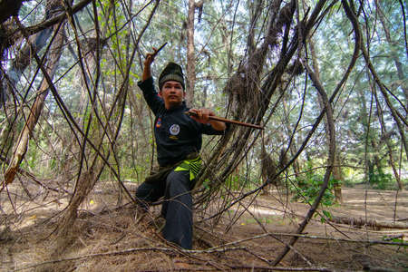 Kelantan/Malaysia - Jul 15 2017: Silat art master with his knife.のeditorial素材