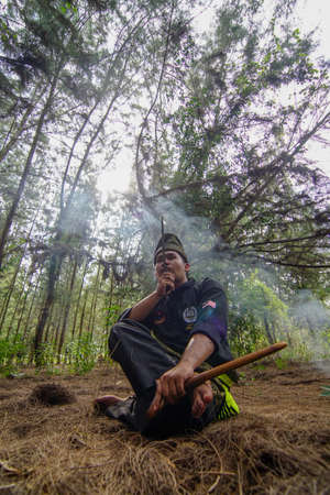 Kelantan/Malaysia - Jul 15 2017: Silat martial art master sit with his knife.のeditorial素材