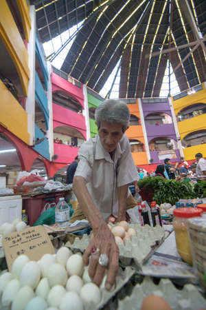 Kelantan/Malaysia - Jul 15 2017: A man sell salted egg at pasar Siti Khdijah.のeditorial素材