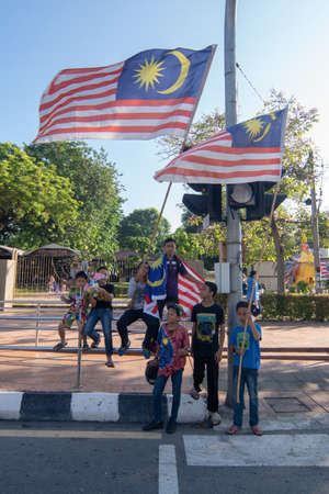 George Town, Penang/Malaysia - Aug 31 2017: Kids hold Malaysia flag show patriotism.