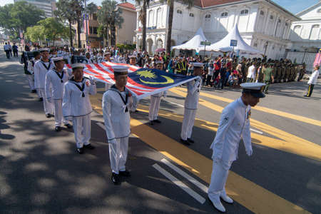 George Town, Penang/Malaysia - Aug 31 2017: Marching while carry Malaysia flag during National day.のeditorial素材