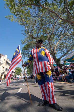 George Town, Penang/Malaysia - Aug 31 2017: An Indian man with Malaysia flag and costume.のeditorial素材