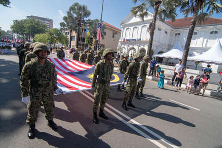 George Town, Penang/Malaysia - Aug 31 2017: Malaysia soldier marching with Malaysia flag.のeditorial素材