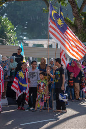 George Town, Penang/Malaysia - Aug 31 2017: Malaysian hold Malaysia flag at street.のeditorial素材
