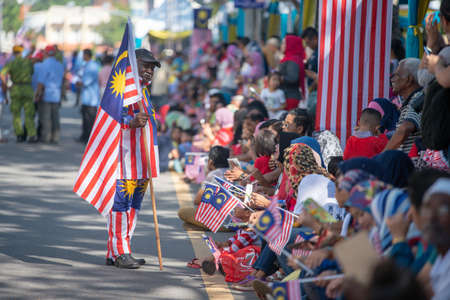 George Town, Penang/Malaysia - Aug 31 2017: A man hold Malaysia flag at national day parade.のeditorial素材