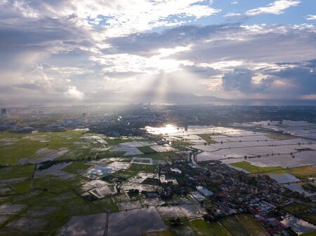 Aerial view magnificent sun ray over paddy field at Perai, Penang.の写真素材