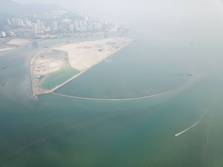 Aerial a boat move over reclamation land in misty morning.の写真素材