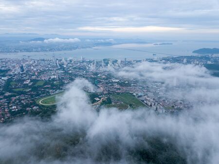 Aerial view sea cloud. Background is Georgetown and Penang Bridge.の写真素材