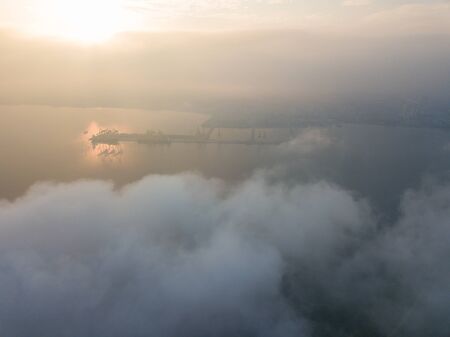 Aerial view Container Terminal in early morning over sea cloud.の写真素材