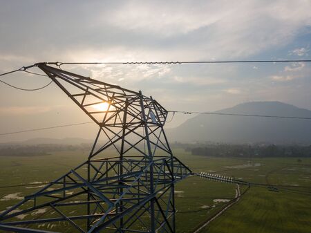 Aerial view sunrise over electric tower. Background is Cherok Tokkun Hill.の写真素材