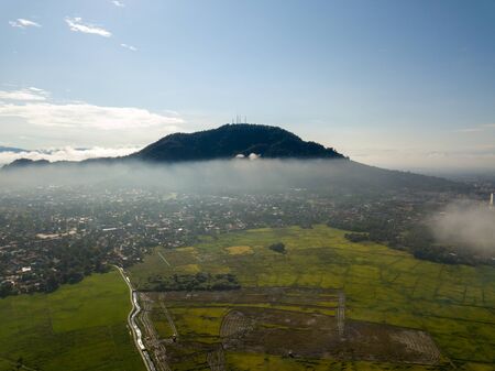 Aerial view paddy field is covered by foggy cloud in afternoon.の写真素材