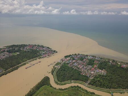 Aerial brown color Sungai Muda river at the border of Penang and Kedah.の写真素材