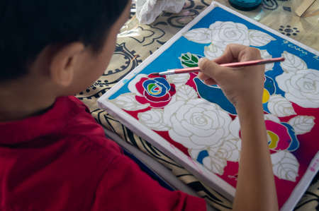GeorgetownPenang/Malaysia - Feb 15 2020: A kid draw batik.