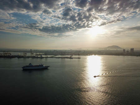 Georgetown, Penang/Malaysia - Feb 28 2020: Cruise ship near container terminal in morning.のeditorial素材