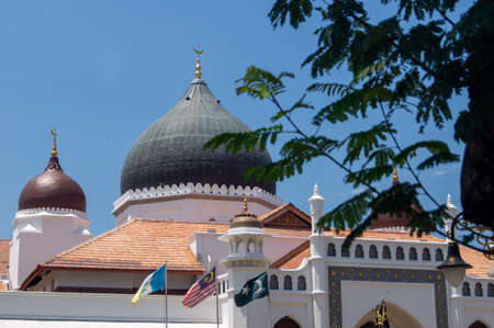 Georgetown, Penang/Malaysia - Feb 28 2020: Masjid Kapitan Keling Mosque with green leaves.