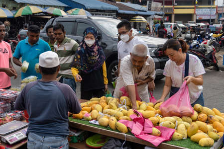 Bukit Mertajam, Penang/Malaysia - Mar 08 2020: People buy fruit at Malaysia morning market.