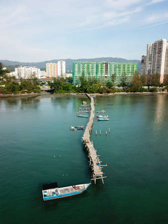 Georgetown, Penang/Malaysia - Mar 17 2020: Aerial view fishing boat park at wooden bridge.のeditorial素材